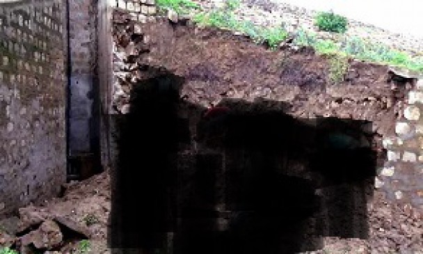 On verge of breaking down reservoir, Returning Wall in Rain