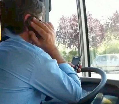 ST bus driver runs on the highway with chatting on the mobile