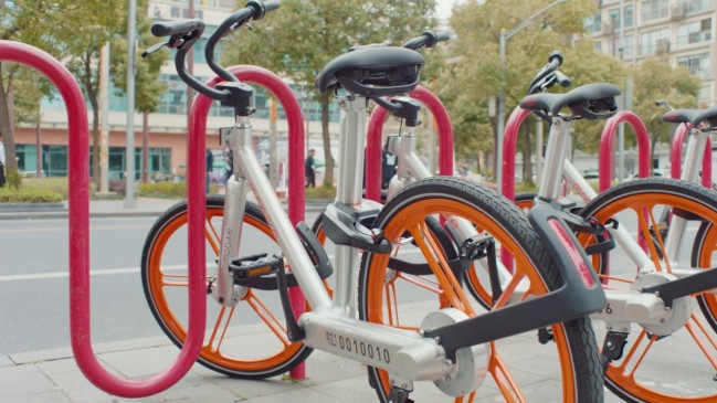 Mobike runs along with the Metro train in the city of oranges