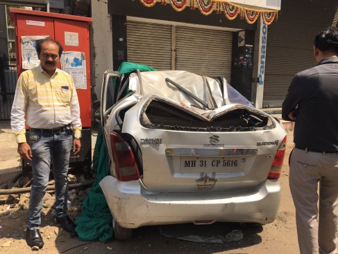 Iron frame dropped on car near the metro site, crushed on spot