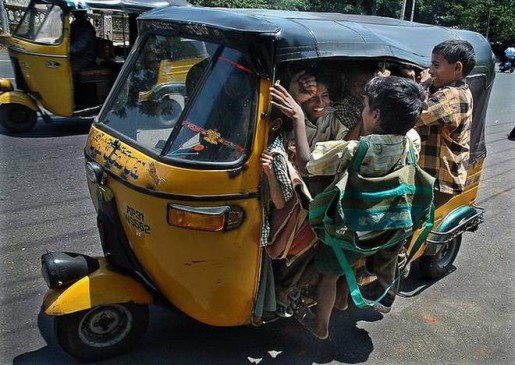 Carelessness : Auto rickshaw run fast with Children, school bags hanging outside