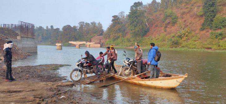 Villagers cross the river after putting their lives in danger