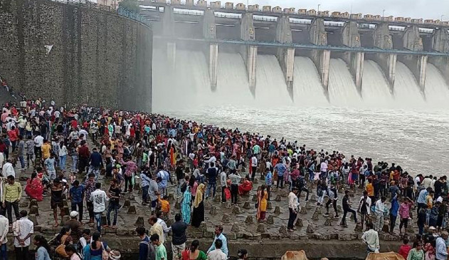 Upper Wardha Dam illuminated with rainbow colors, crowd of tourists Upper Wardha Dam illuminated with rainbow colors, crowd of tourists
