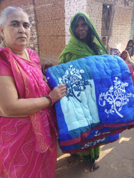 Retired teacher along with his wife are distributing quilts to the needy